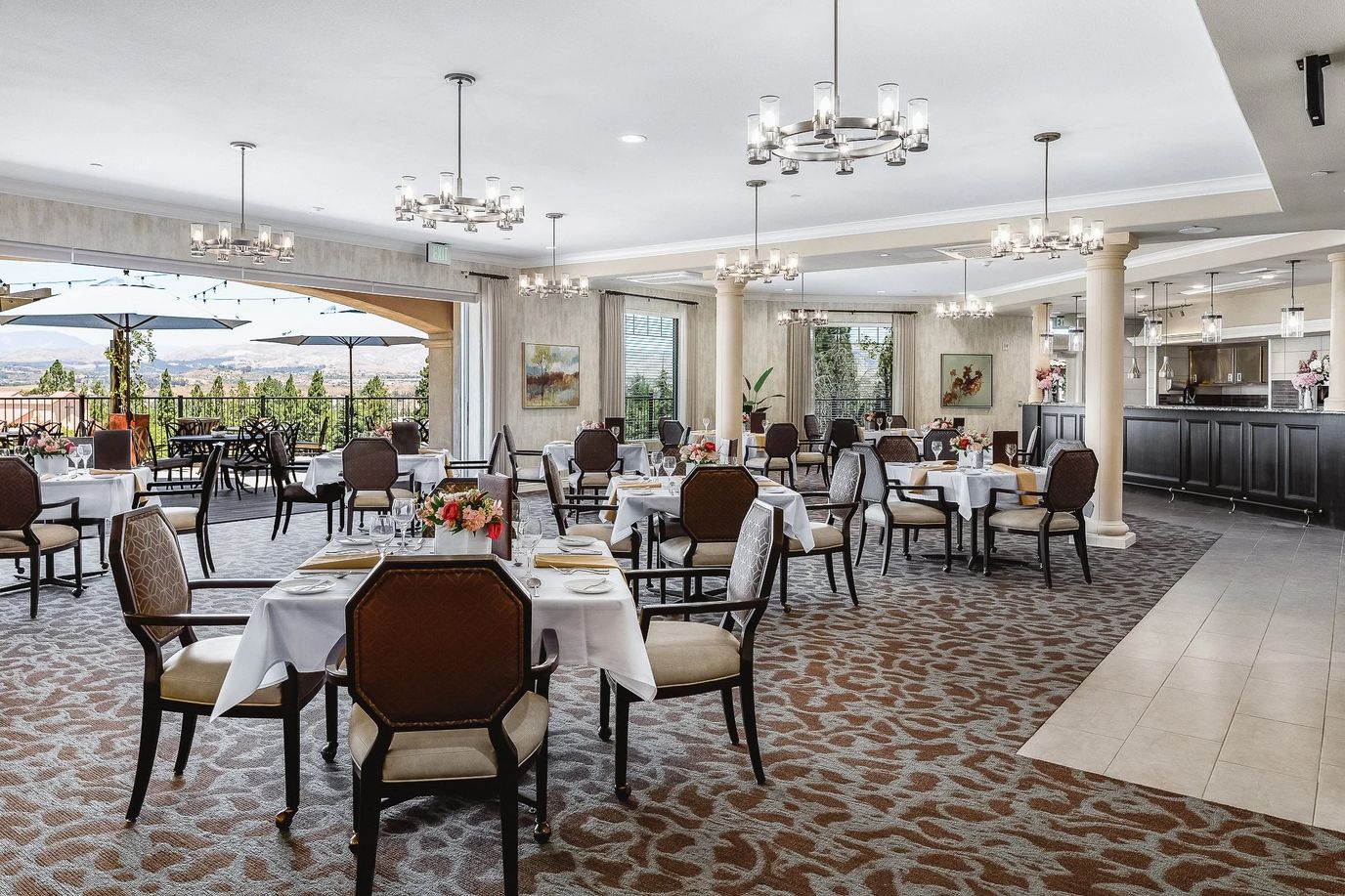 Elegant dining room with tables set for residents