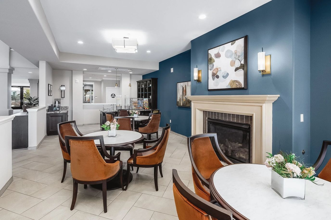 Bright common area with tables and chairs.