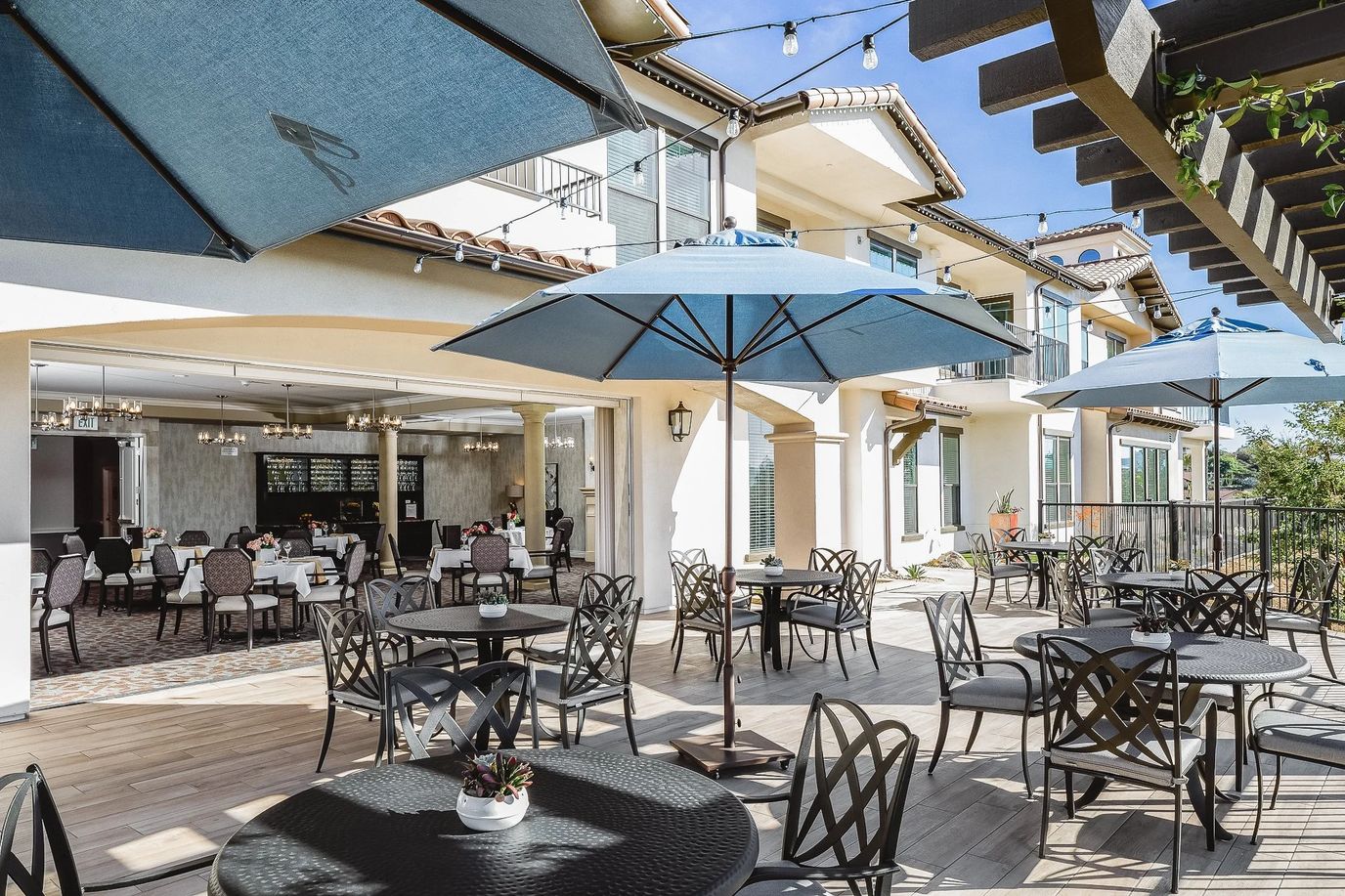 Outdoor seating area with umbrellas and views of the building