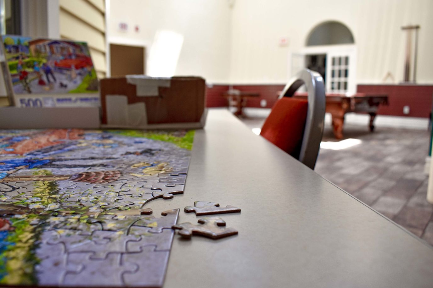 Puzzle pieces on a table in a common area