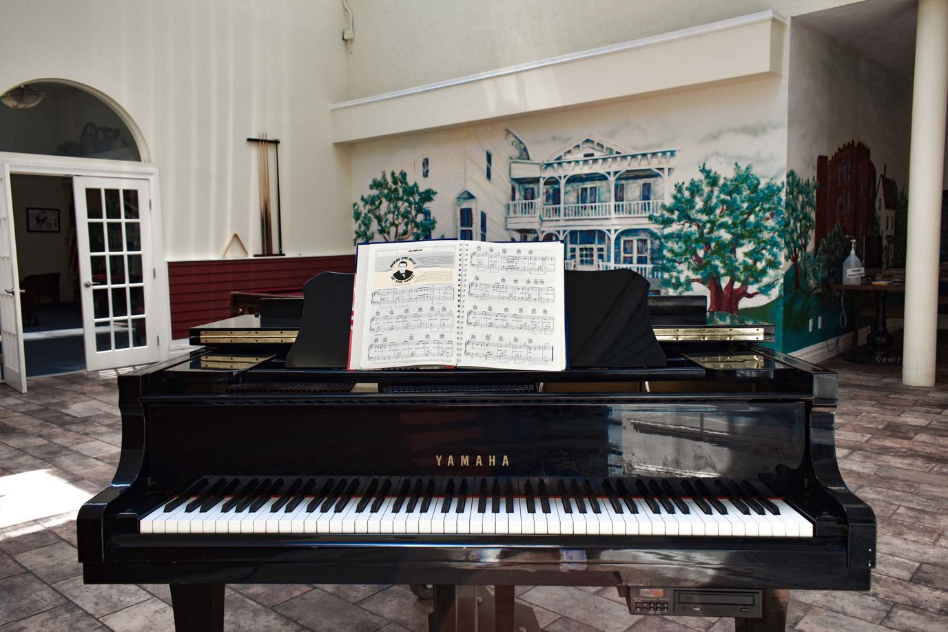 Piano in a common area with music sheets
