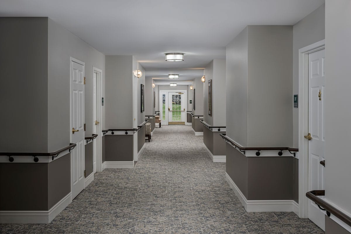 A hallway in the assisted living facility with doors and windows