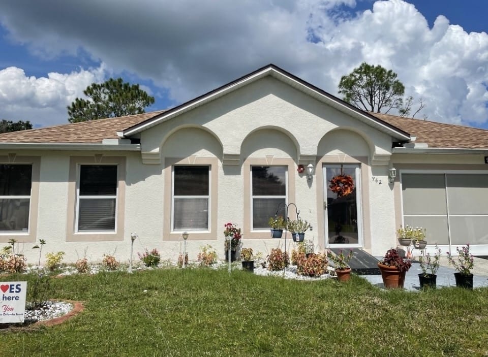 Exterior view of a single-story building with flowers