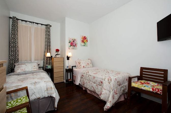 Cozy shared resident room with twin beds and decor