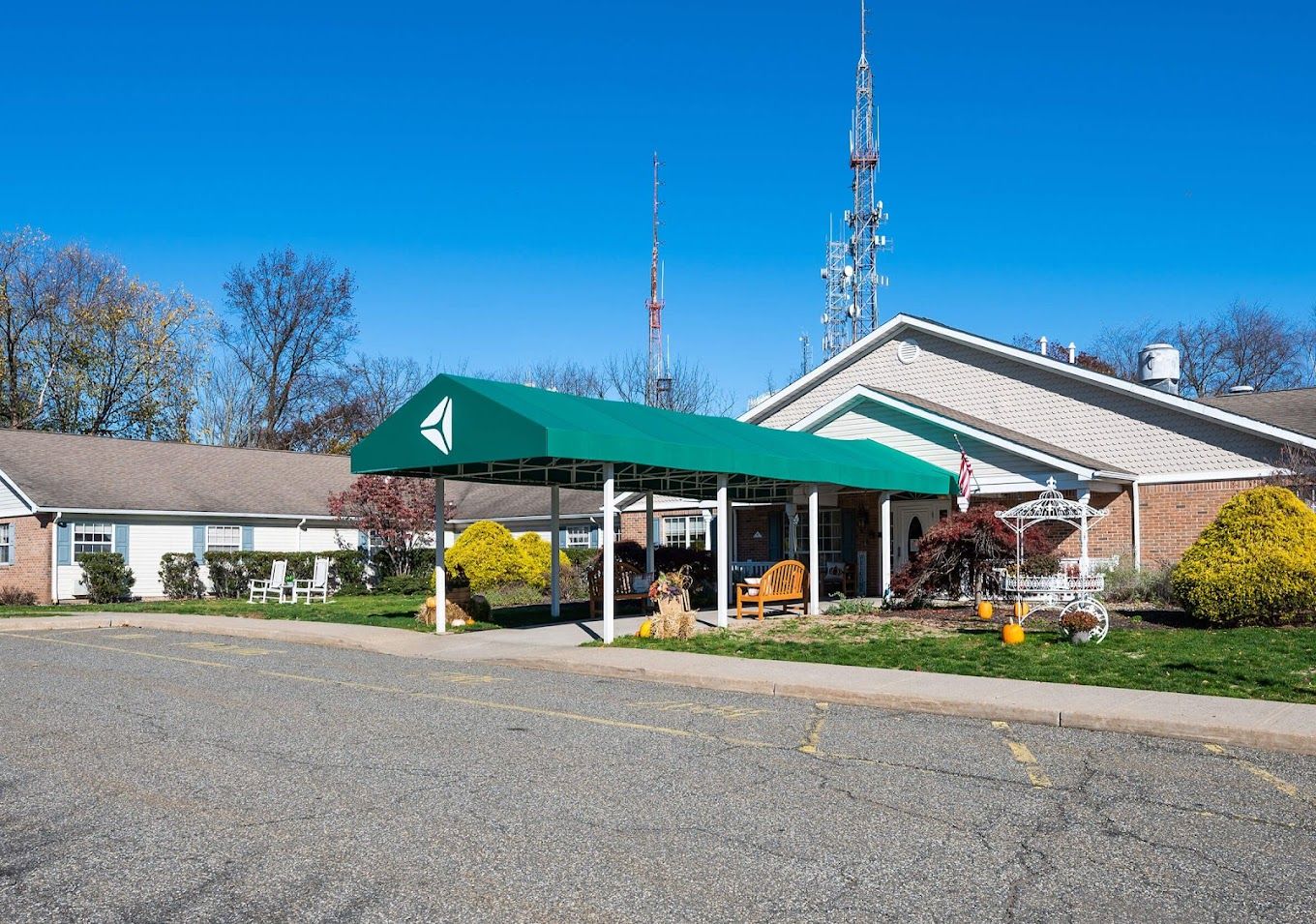 Exterior view of a senior living community building with a canopy