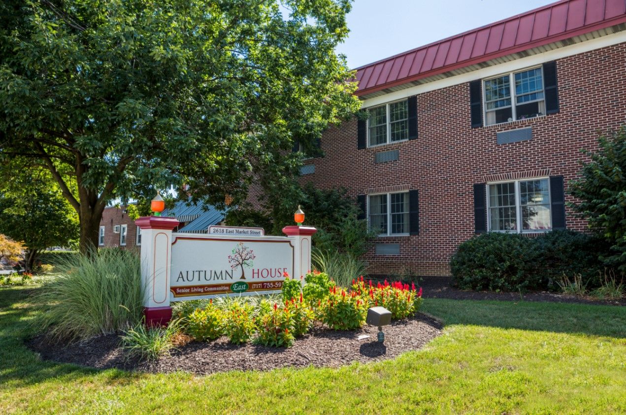 Exterior of Autumn House East with landscaping and signage