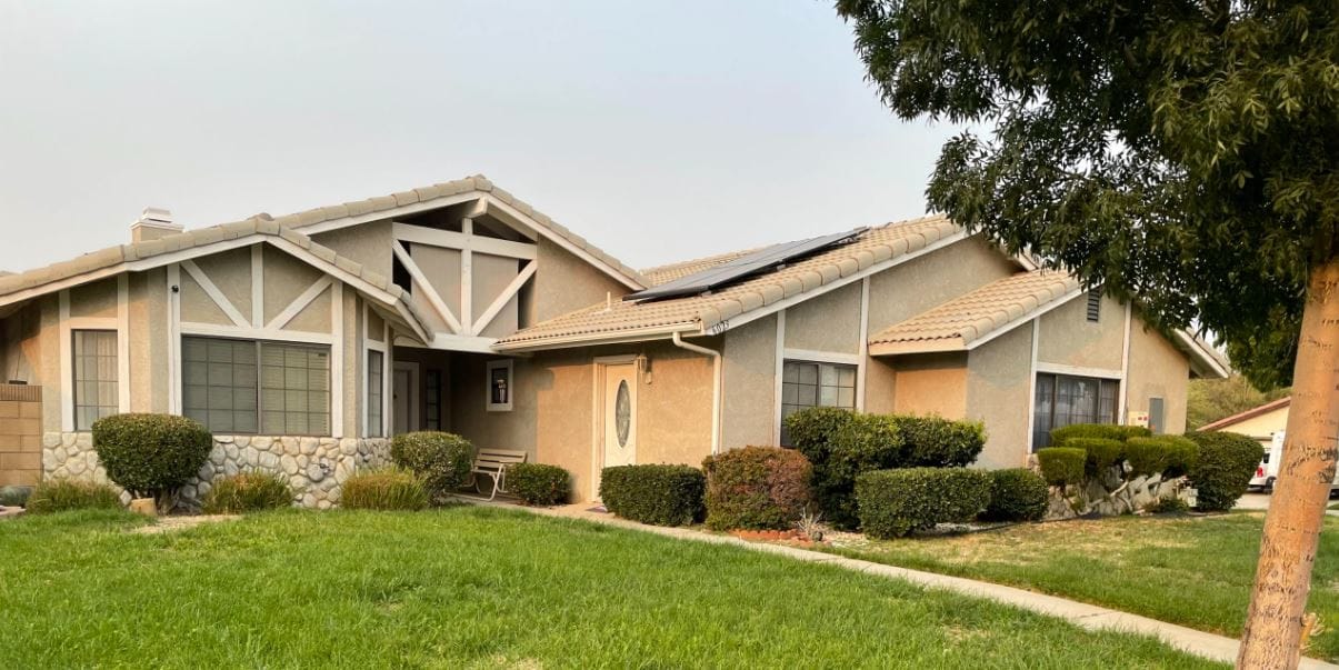 Exterior view of a senior living facility with landscaping