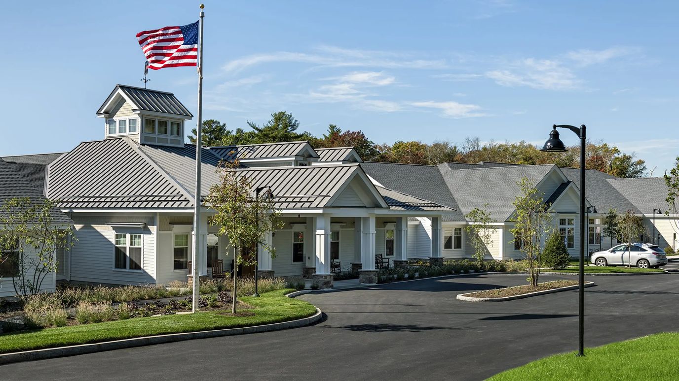 Exterior view of the senior living facility with flag