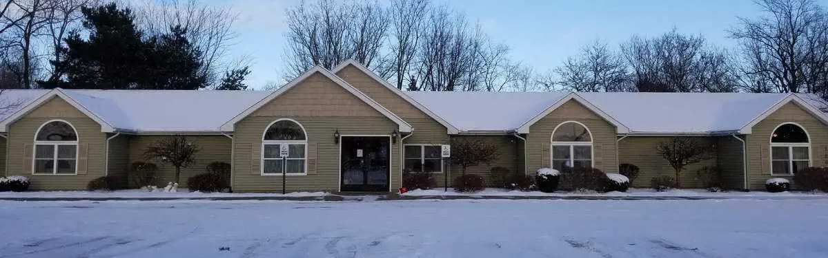 Exterior view of the assisted living facility covered in snow