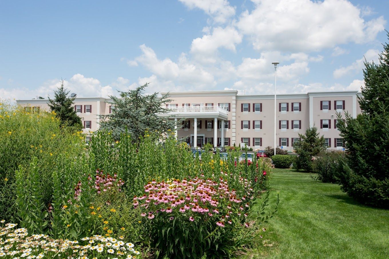 Exterior view of the facility with landscaped gardens