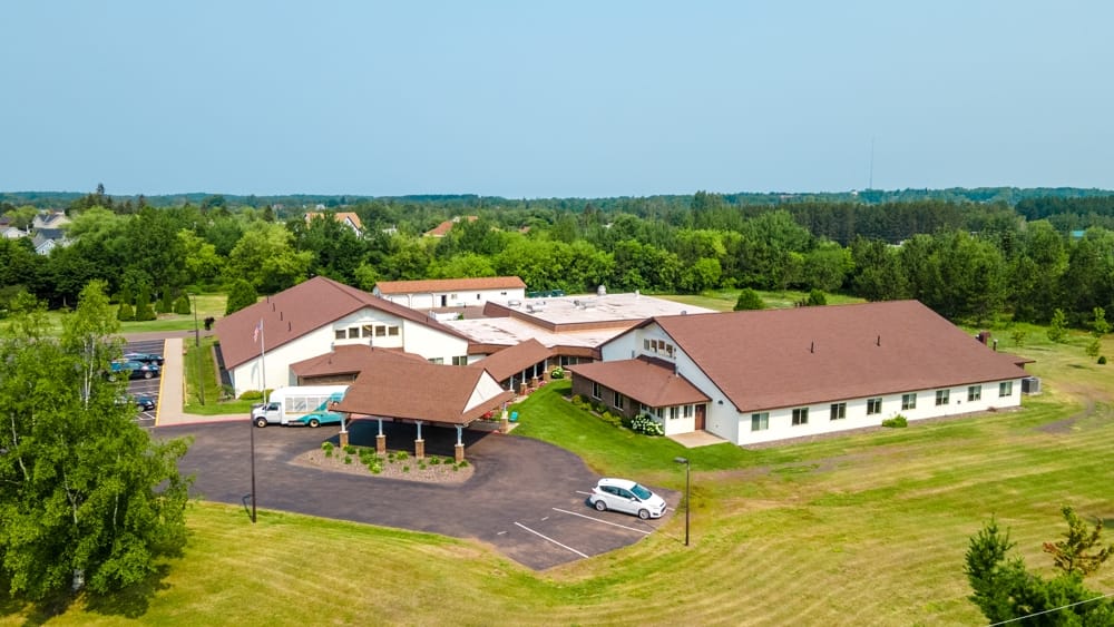 Aerial view of a senior living facility with outdoor space