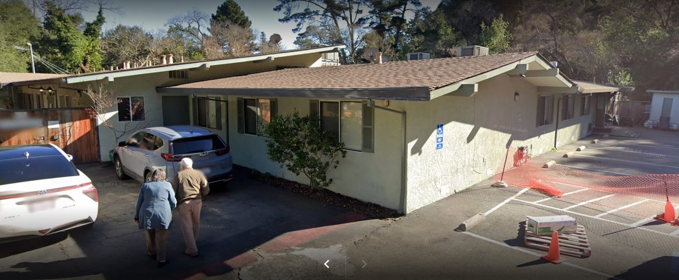 Exterior view of the facility with residents walking