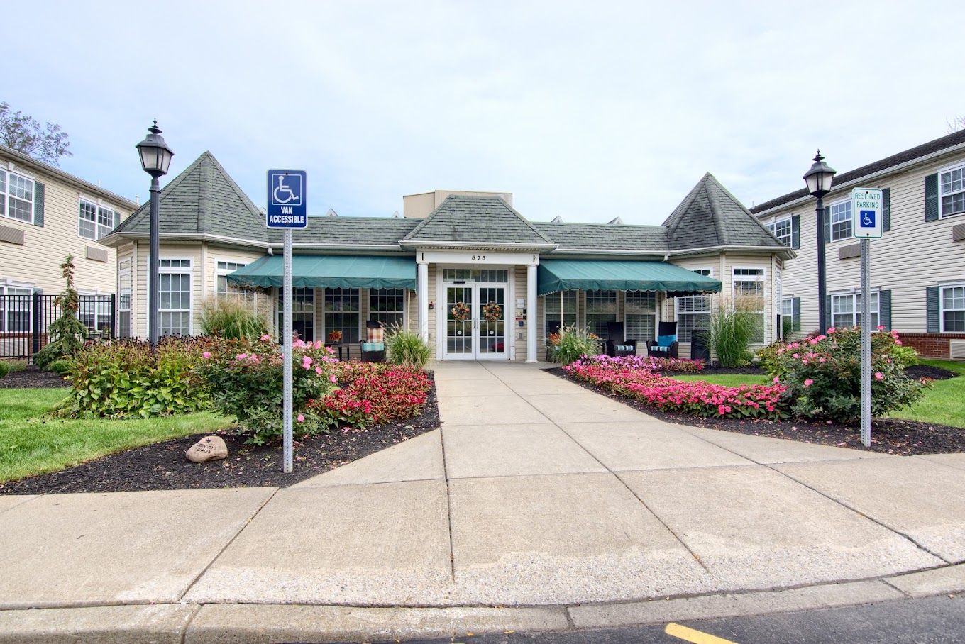 Exterior view of Peregrine Senior Living with colorful landscaping