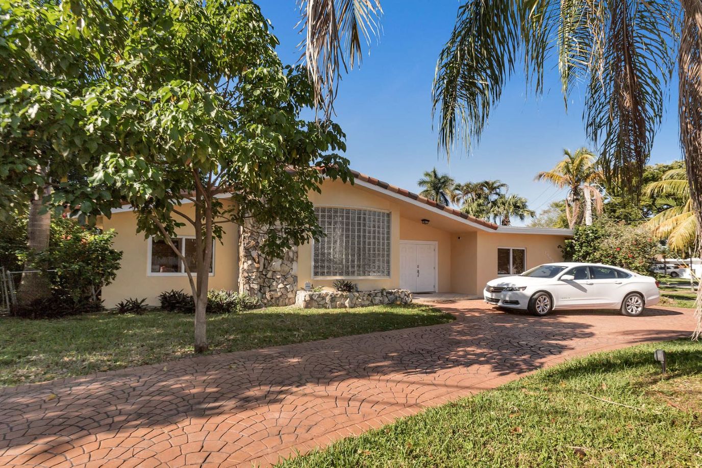 Exterior view of a senior living facility with palm trees