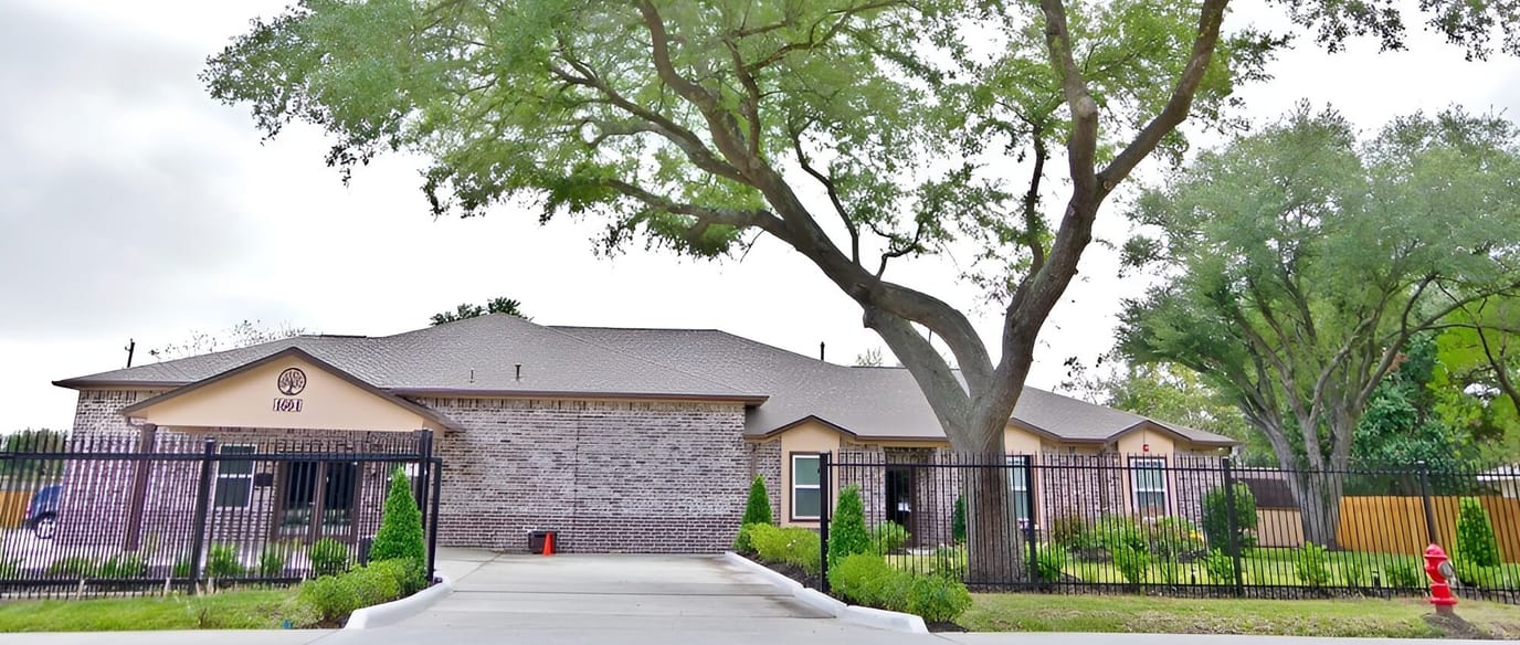 Exterior view of a senior living facility with garden