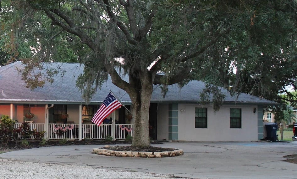 Exterior view of assisted living facility with a flag