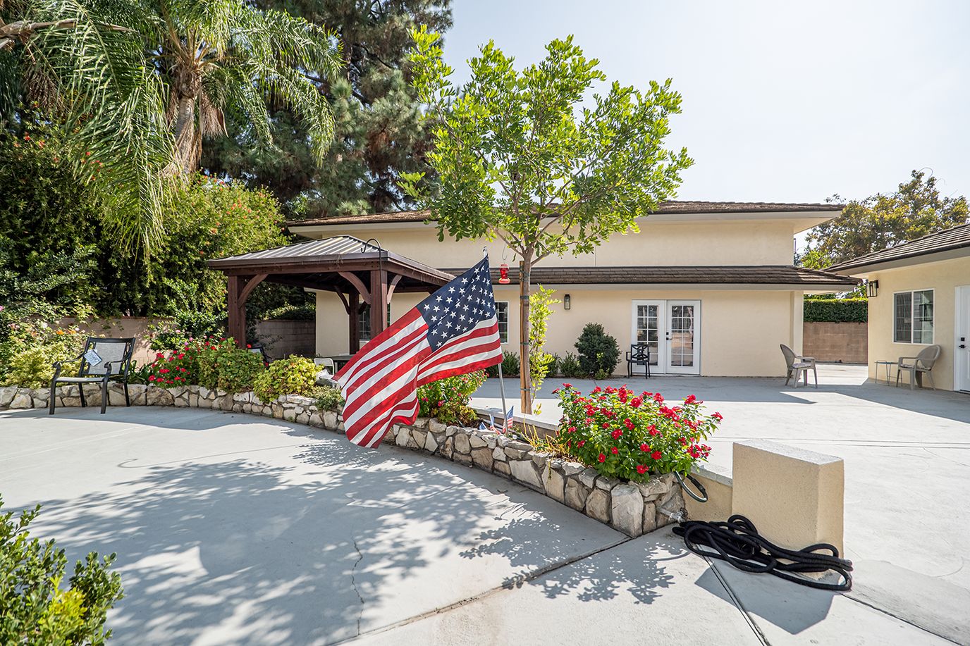Outdoor view of facility with garden and flag