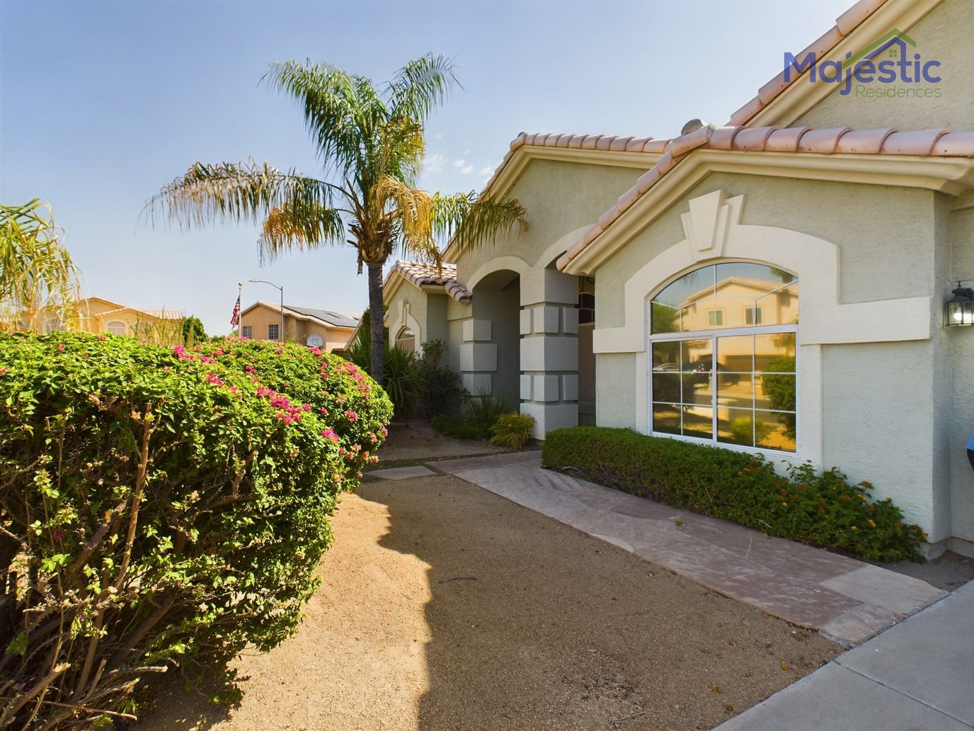 Exterior view of a senior living facility with landscaped garden.