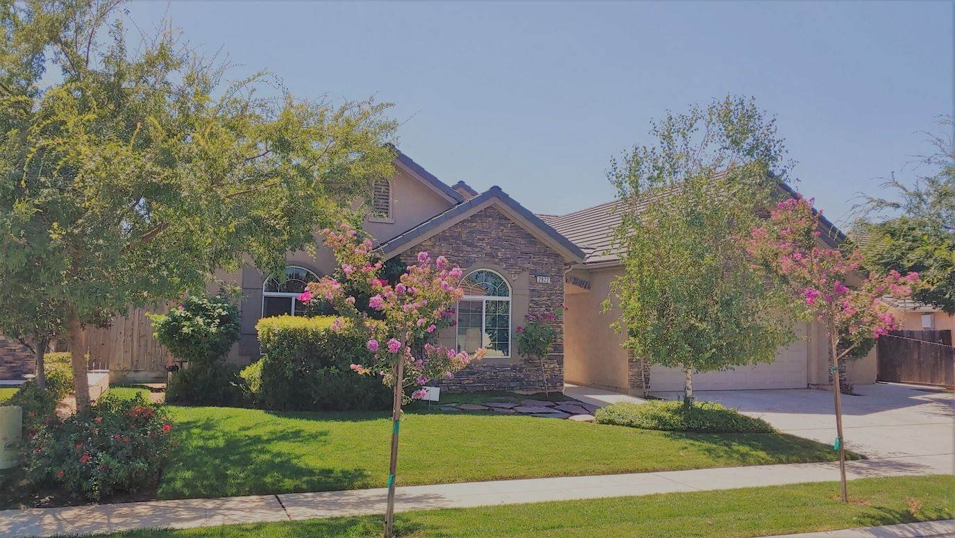 Exterior view of a senior living facility with gardens