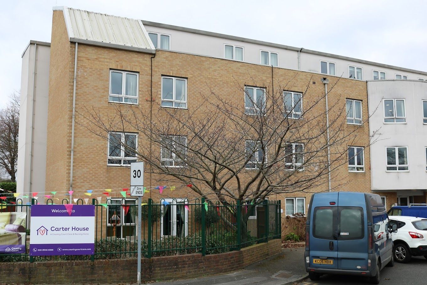 Exterior view of Carter House Care Home with trees