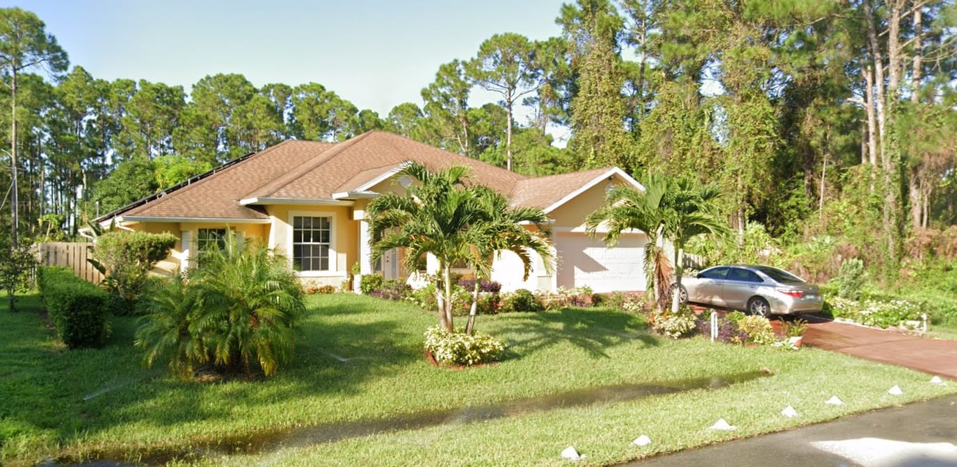 Exterior view of an assisted living facility surrounded by greenery