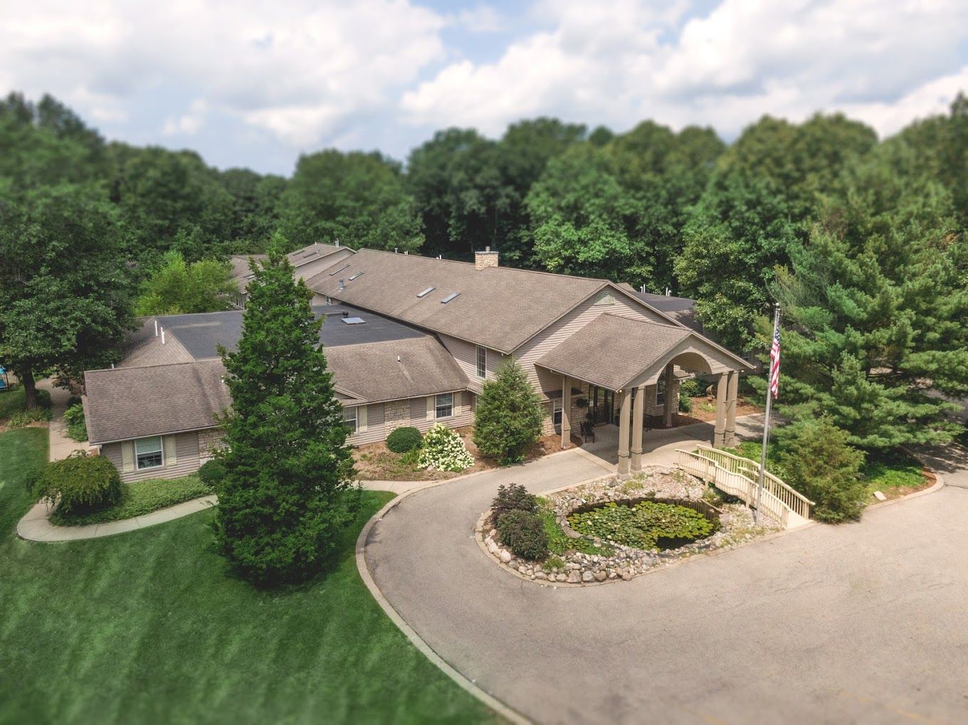 Aerial view of an assisted living facility surrounded by greenery
