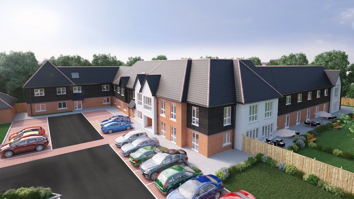 Exterior view of Greenwood Court Care Home with parking area