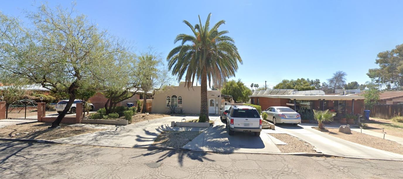 Front exterior of La Paz Assisted Living II with palm trees