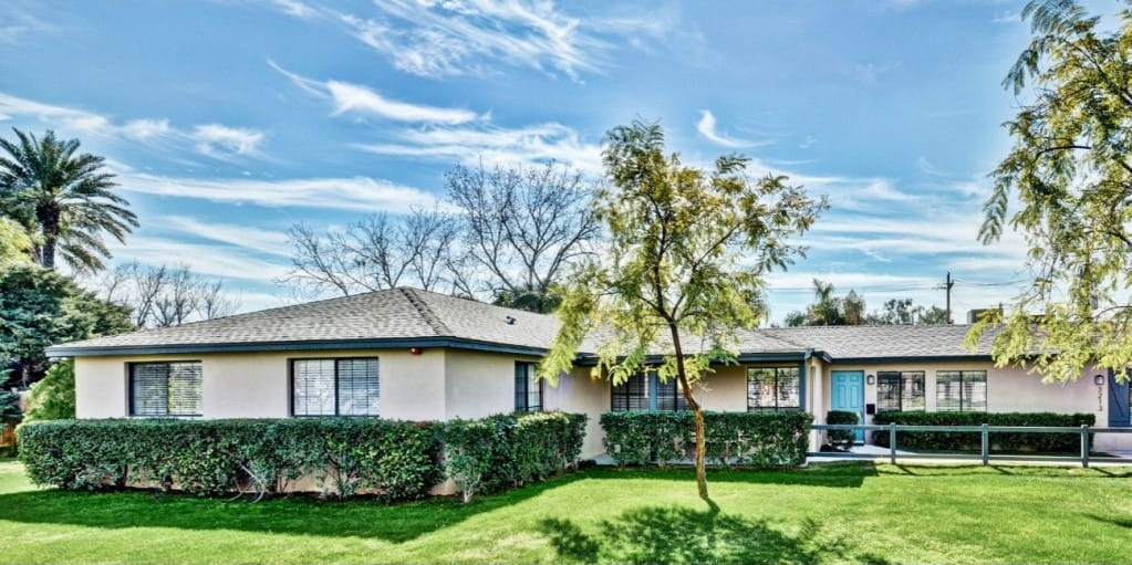 Exterior view of the assisted living facility with landscaping