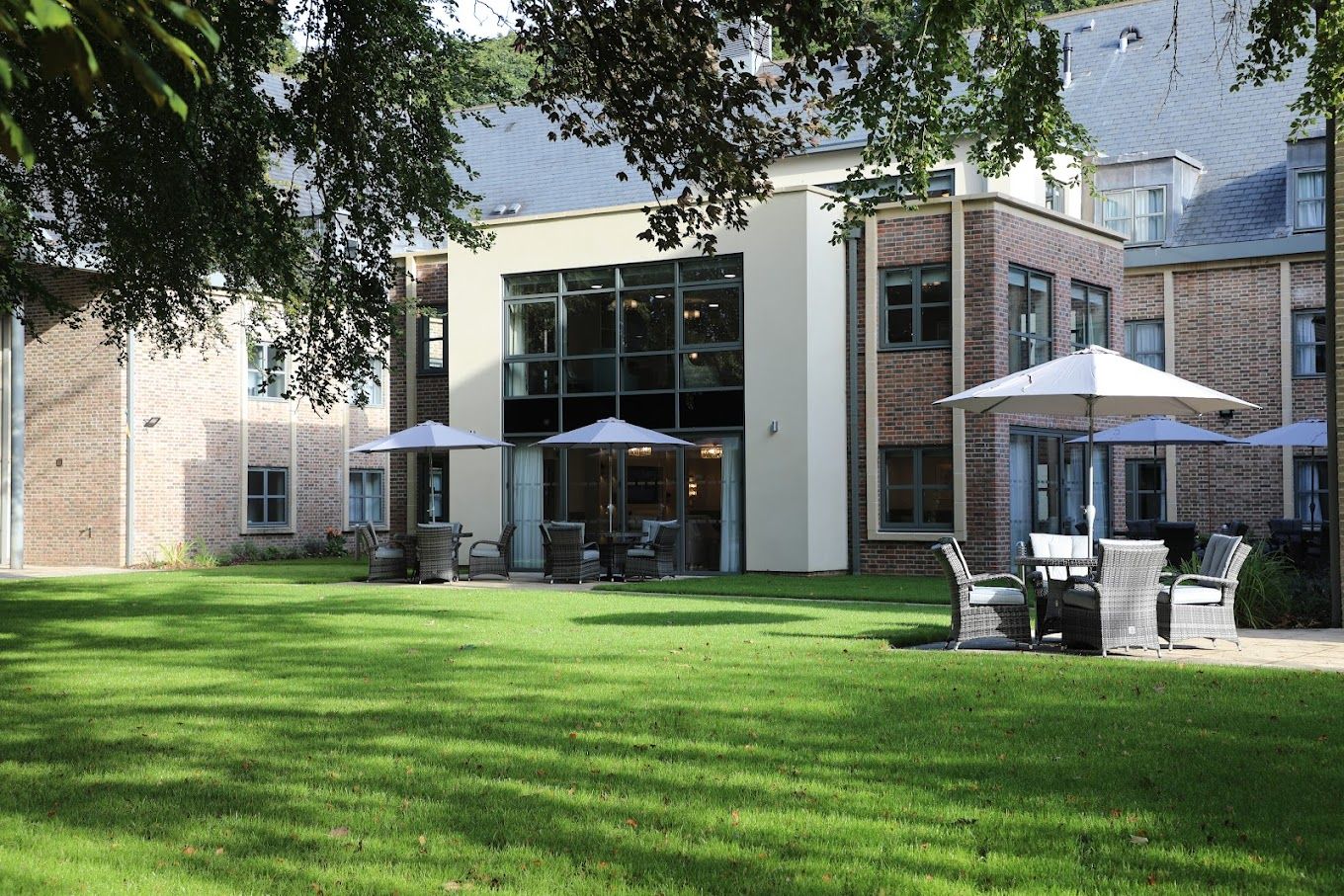 Exterior view of the assisted living facility with outdoor seating