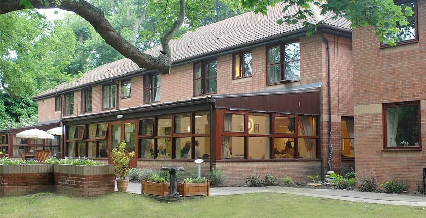 Exterior view of The Grove Care Home with garden area