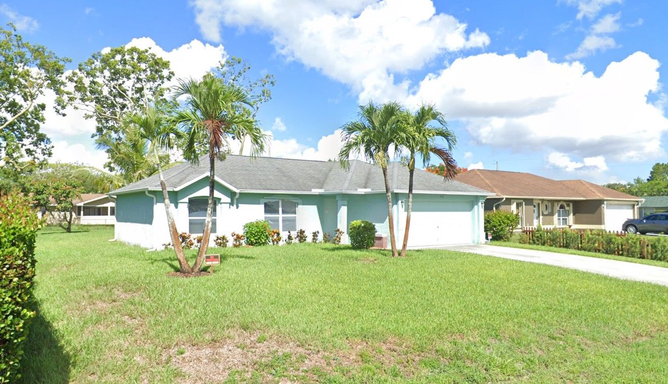 Exterior view of a single-story building with green grass