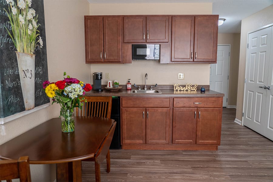 Interior view of a resident's kitchen area with flowers