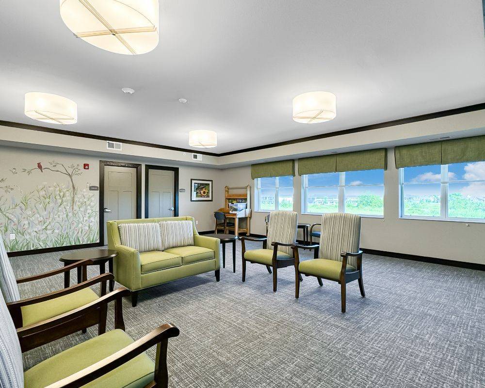 Bright common area with green and beige furnishings