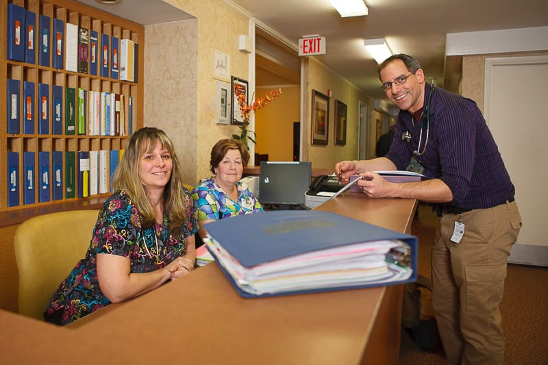Reception area with smiling staff members