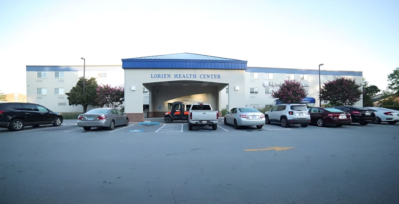 Exterior view of Lorien Health Center with parked cars