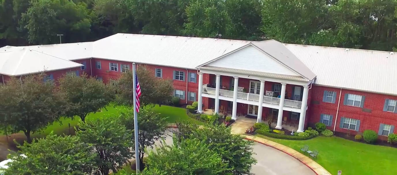 Aerial view of the building exterior with landscaping