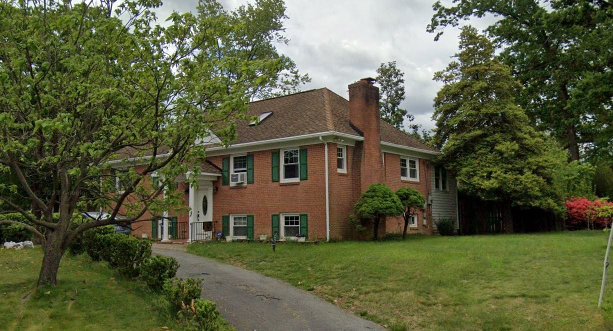 Exterior view of Emilia Assisted Living Home with surrounding greenery