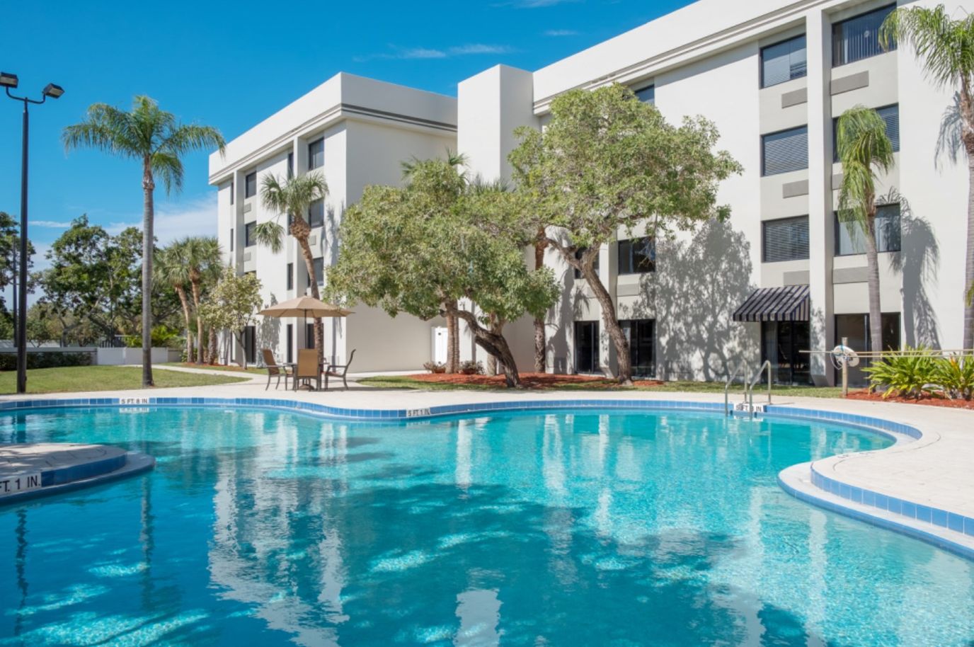 Outdoor pool area adjacent to building