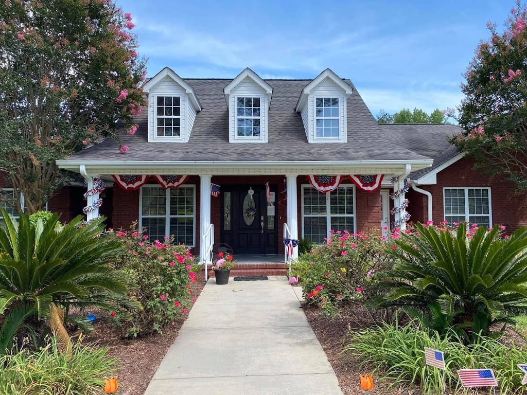 Exterior view of Greenwood Place AL with flowers