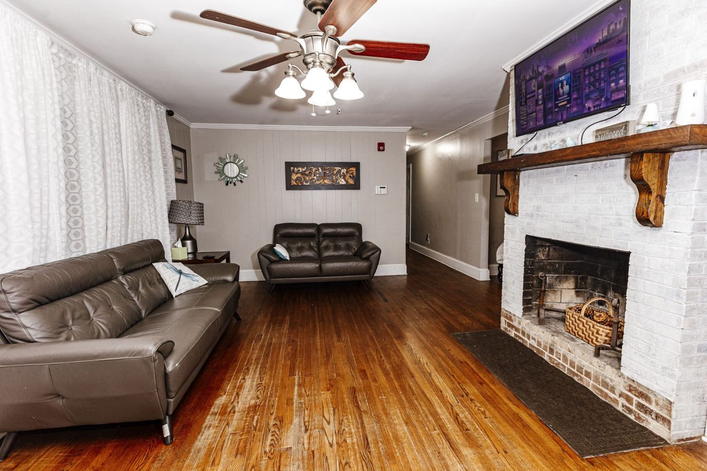 Living room featuring sofas, a lamp, and a fireplace.
