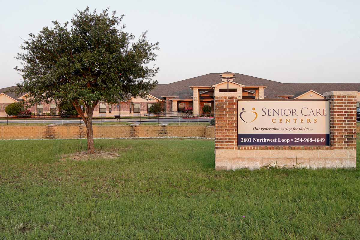 Exterior view of the senior care facility with sign