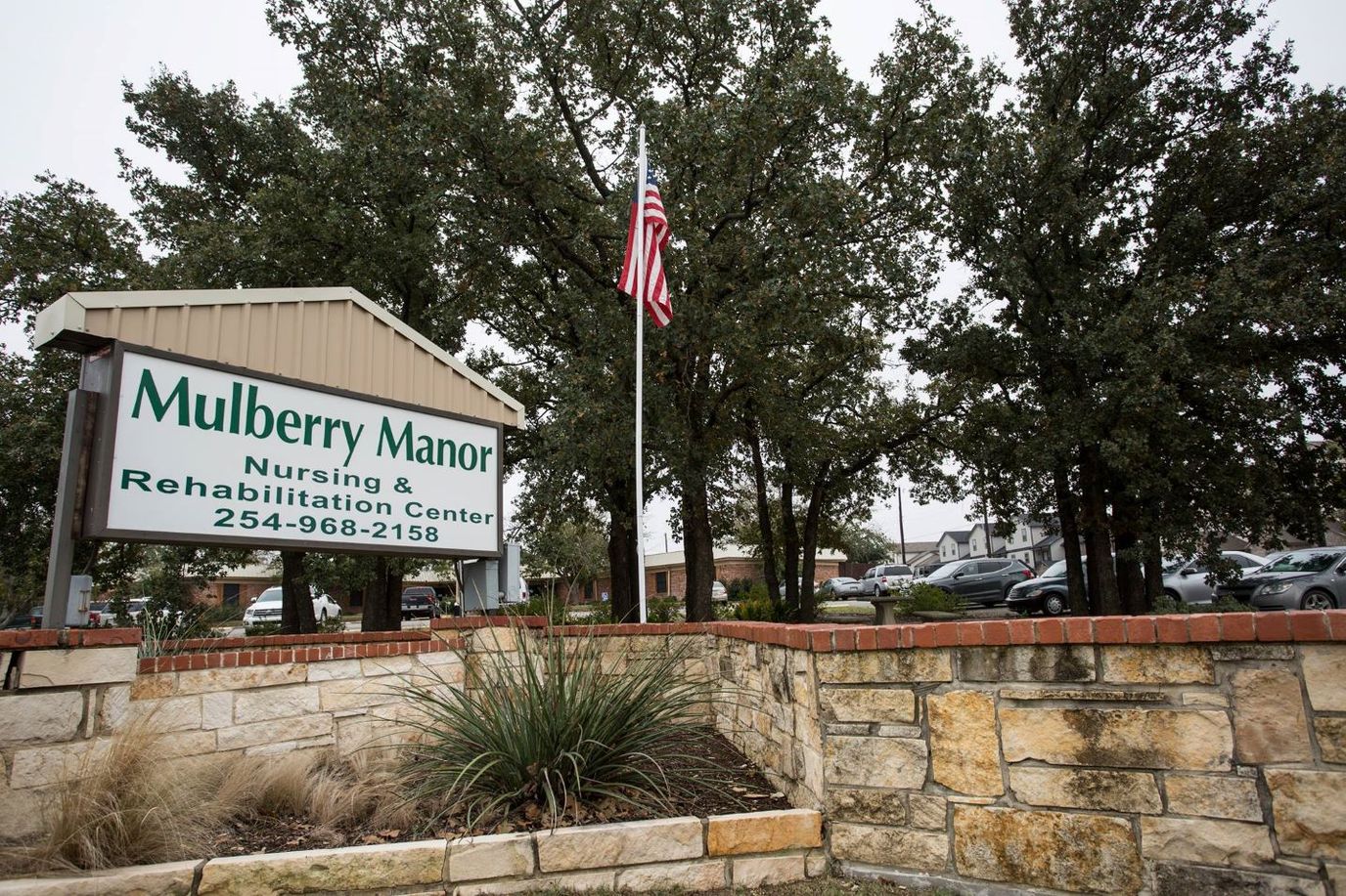 Exterior photo of Mulberry Manor nursing home with American flag