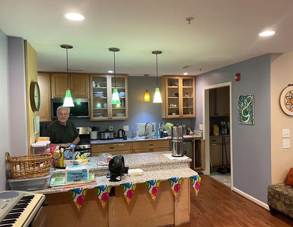 A resident enjoying time in the facility kitchen.
