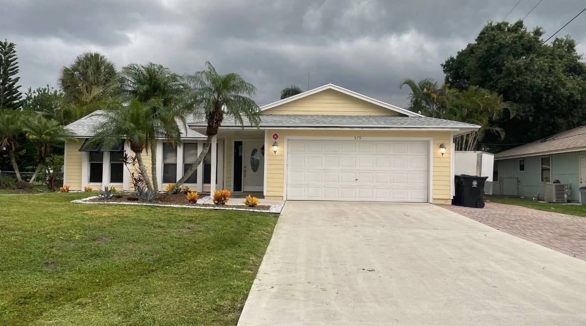Exterior view of a single-family home with a garden