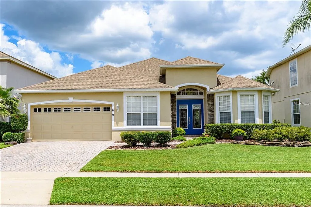 Exterior view of a residential building with landscaped yard