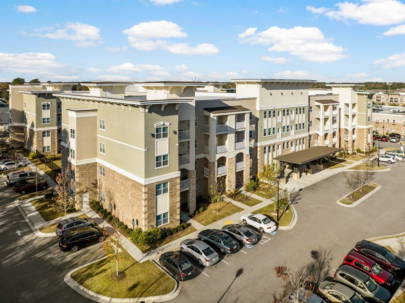 Aerial view of the exterior of the facility with cars parked.