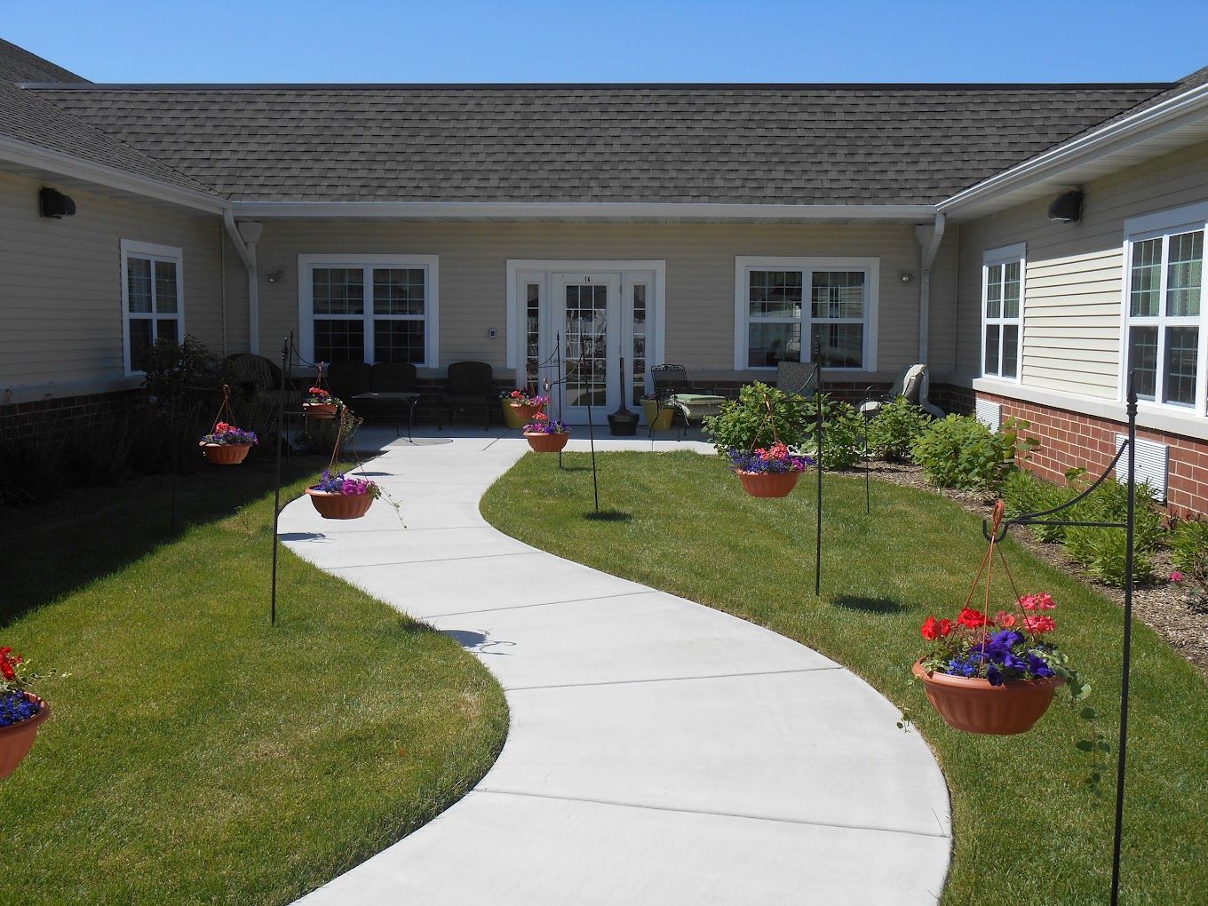 Pathway through the outdoor garden with hanging flower pots