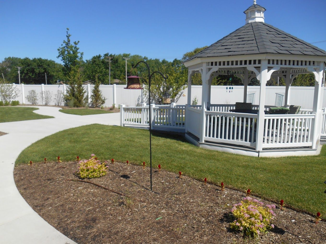 Outdoor space featuring a gazebo and landscaped garden