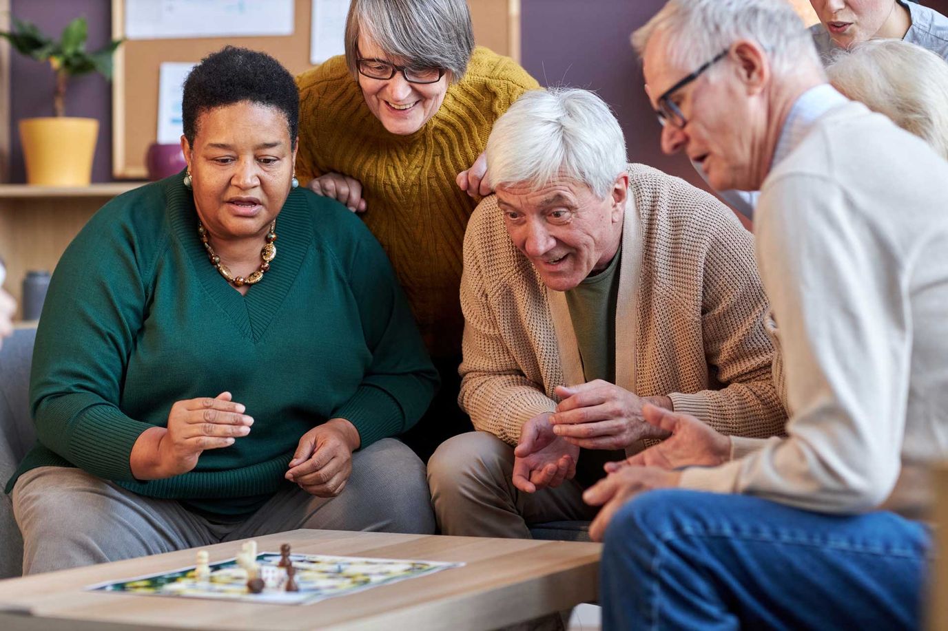 Poet’s Walk Leesburg, assisted living in Leesburg, VA — Seniors enjoying a board game together in a common area